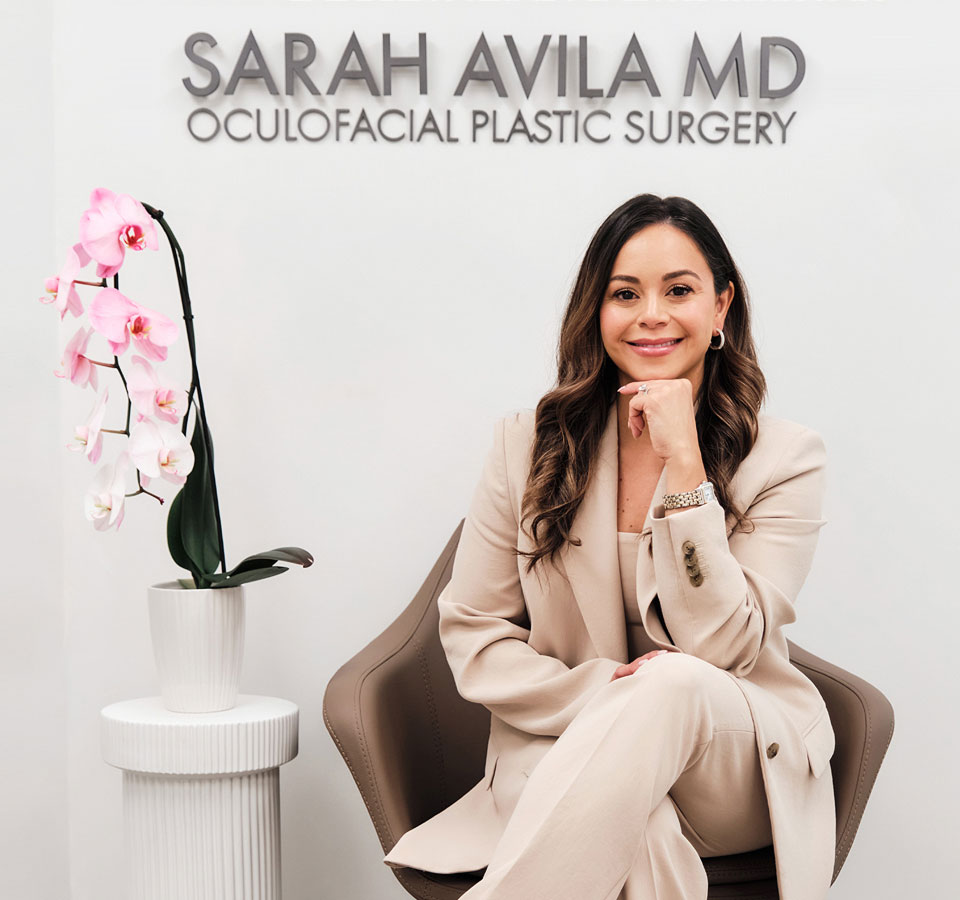 Dr. Avila is smiling in sitting position