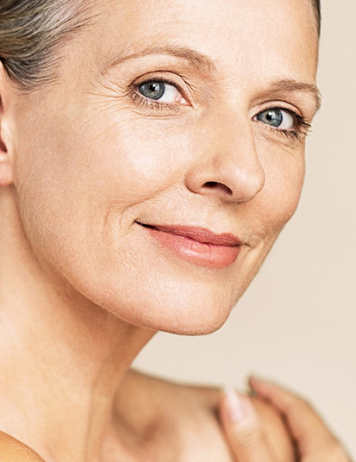 Portrait of beauty mature woman isolated over grey background Non Surgical